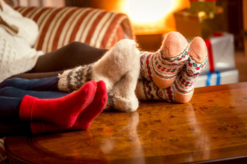 Closeup conceptual shot of family warming feet at fireplace