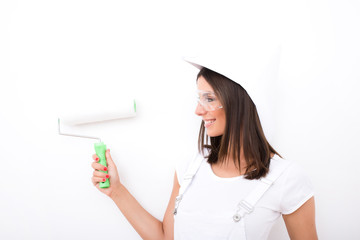 Beautiful young woman painting a Apartment