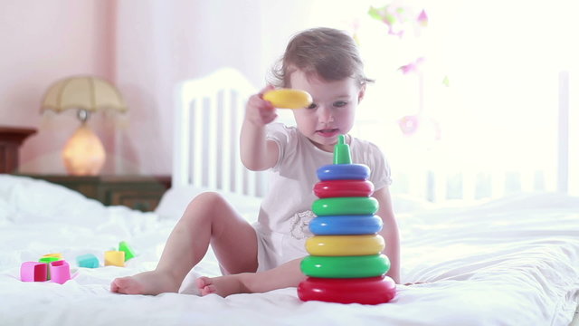 Baby playing with a toy pyramid