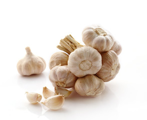 Fresh organic garlic isolated on white, selective focus.