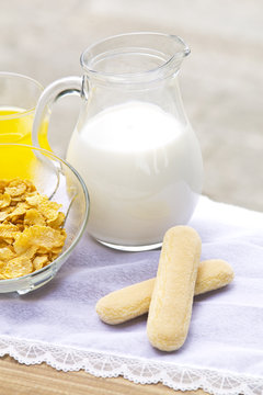 jug of milk with biscuits and cereals