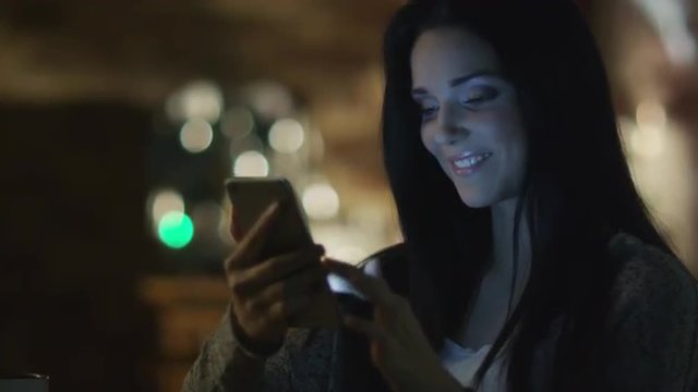 Teen Girl with Beautiful Smile is Using Smartphone at Evening. Casual Lifestyle.