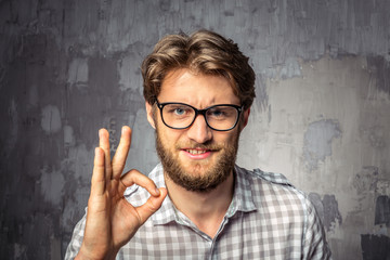 Young handsome man showing OK sign