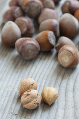 Hazelnuts on old wooden background