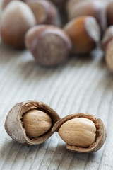 Hazelnuts on old wooden background
