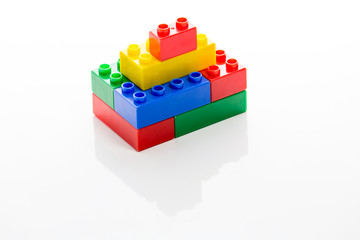 Colorful plastic bricks forming house
