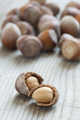 Hazelnuts on old wooden background