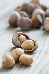 Hazelnuts on old wooden background