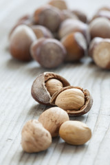 Hazelnuts on old wooden background