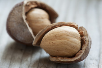 Hazelnuts on old wooden background