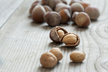 Hazelnuts on old wooden background