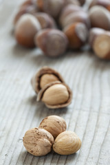 Hazelnuts on old wooden background
