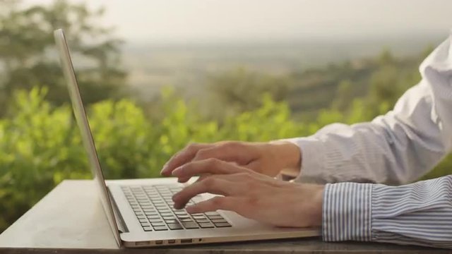 Businessman Using Laptop Oudoors