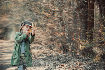little girl playing with a slingshot