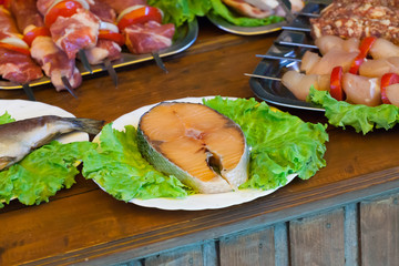 stake of a salmon  white plate with greens