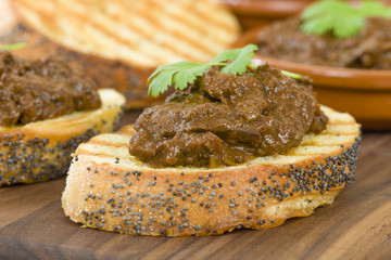 Higados de Pollo - Chicken livers with chorizo & spring onions finished with a dark Cajun tomato sauce on top of crusty bread.
