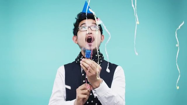 Crazy Face Asian Man Pulling Party Popper Slow Motion Photo Booth Blue Background