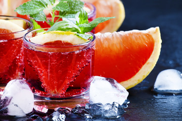 Citrus Red cocktail with grapefruit slices and ice, selective fo