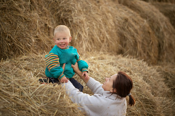 child playing in the straw