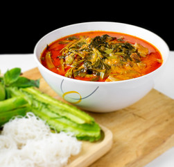 pork red curry with vegetable and noodle on wood table