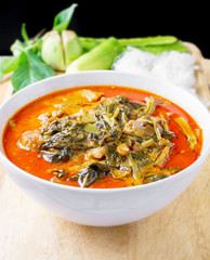 pork red curry with vegetable and noodle on wood table