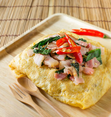 stir fried bacon and basil with fried egg