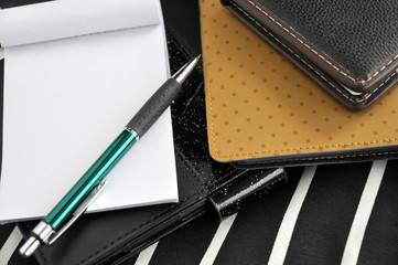 pen and notepad with note book background