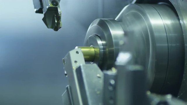 CNC Lathe Machine Produces Metal Detail on Factory.