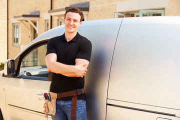 Portrait of a young tradesman by his van © Monkey Business