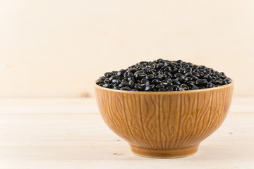 black beans on wood background