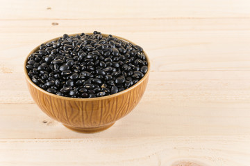 black beans on wood background