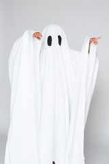 young child dressed in a ghost costume for halloween