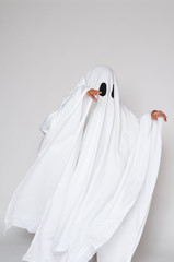 young child dressed in a ghost costume for halloween