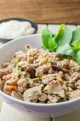 Thai cuisine spicy pork salad on wood table