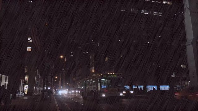 Traffic moves along New York's Fifth Ave. at night during a major rainstorm.