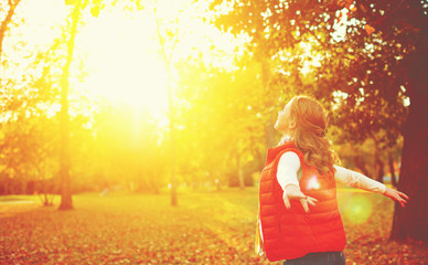 happy girl enjoying life and freedom in the autumn on nature