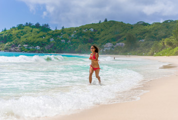 Happy girl at  Beautiful beach on island Mahé in Seychelles - Anse Intendance 