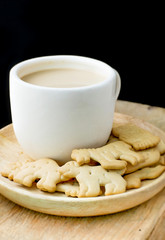Coffee and bread on wooden dish