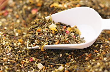 Exotic fruit and flower tea and white sample spoon closeup image - 91579097