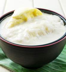 Durian sticky rice on black bowl and banana leaf