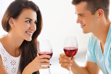 Young couple drinking wine. Romantic relationship.