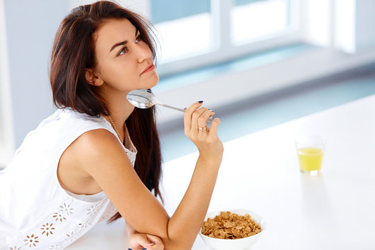 Wellness concept. Woman eating cereal and smiling. Healthy break