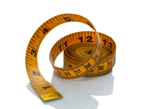 Rolled tape measure on white background