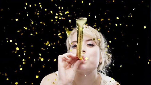 Sexy blonde woman blowing party blower slow motion photo booth