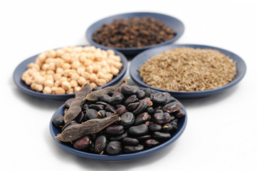 beans,chick-pea, cumin and black pepper on the plates