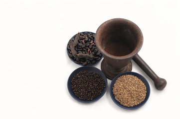 vintage pestle with various seeds and spices