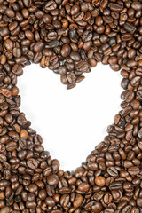 Heart shape in coffee beans heap on white background.