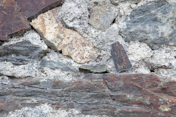 Grey wall of stone damaged