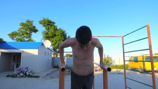 The young man pressed on the bars