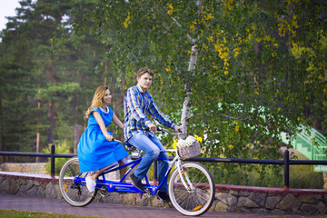 Loving couple riding on a tandem bike